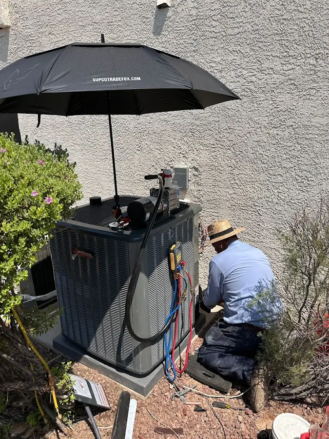 HVAC technician performing outdoor AC maintenance in Wakefield